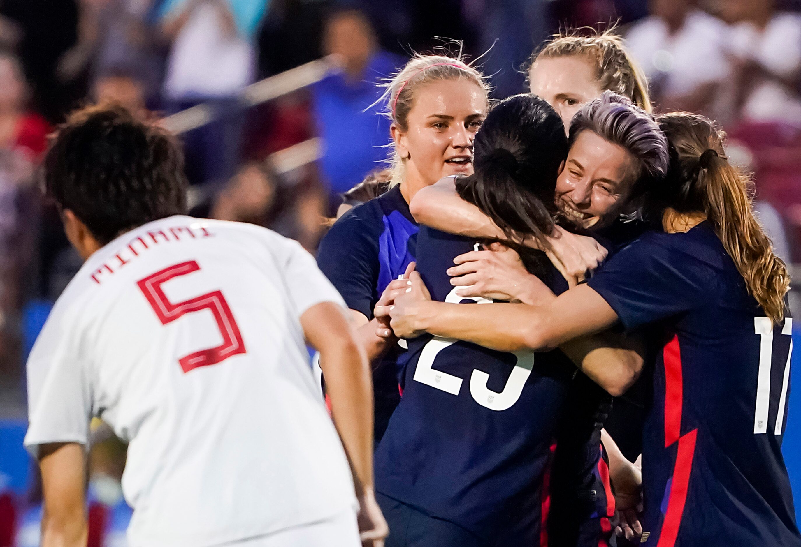 USA forward Megan Rapinoe (facing) celebrates wiith forward Christen Press (23) after Press...