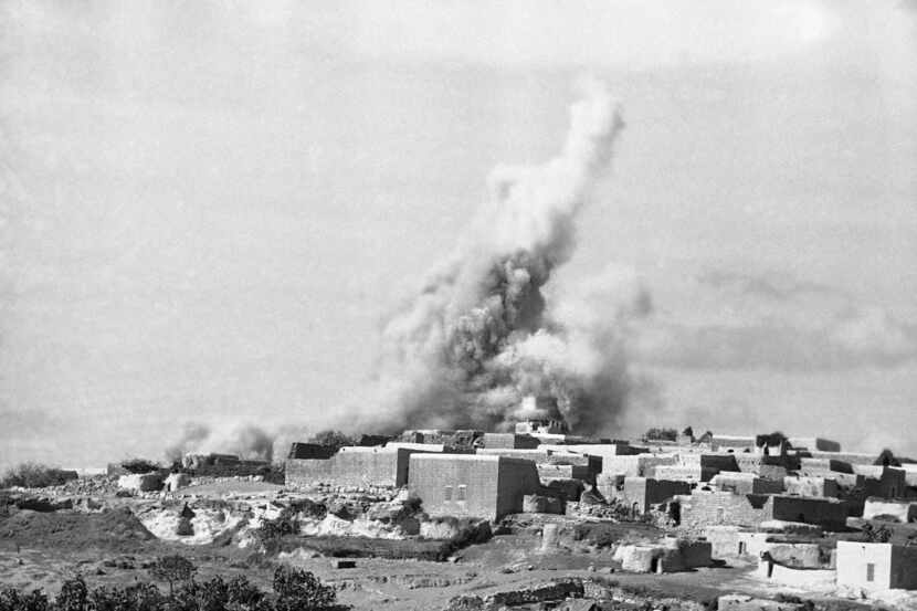 The British army dynamites stone houses in an Arab town in northern Mandatory Palestine in...