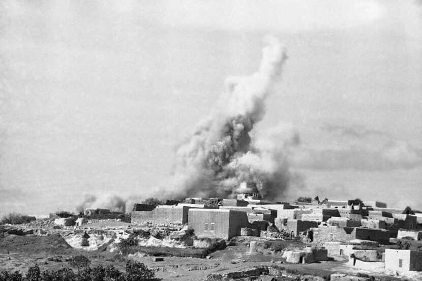 The British army dynamites stone houses in an Arab town in northern Mandatory Palestine in...