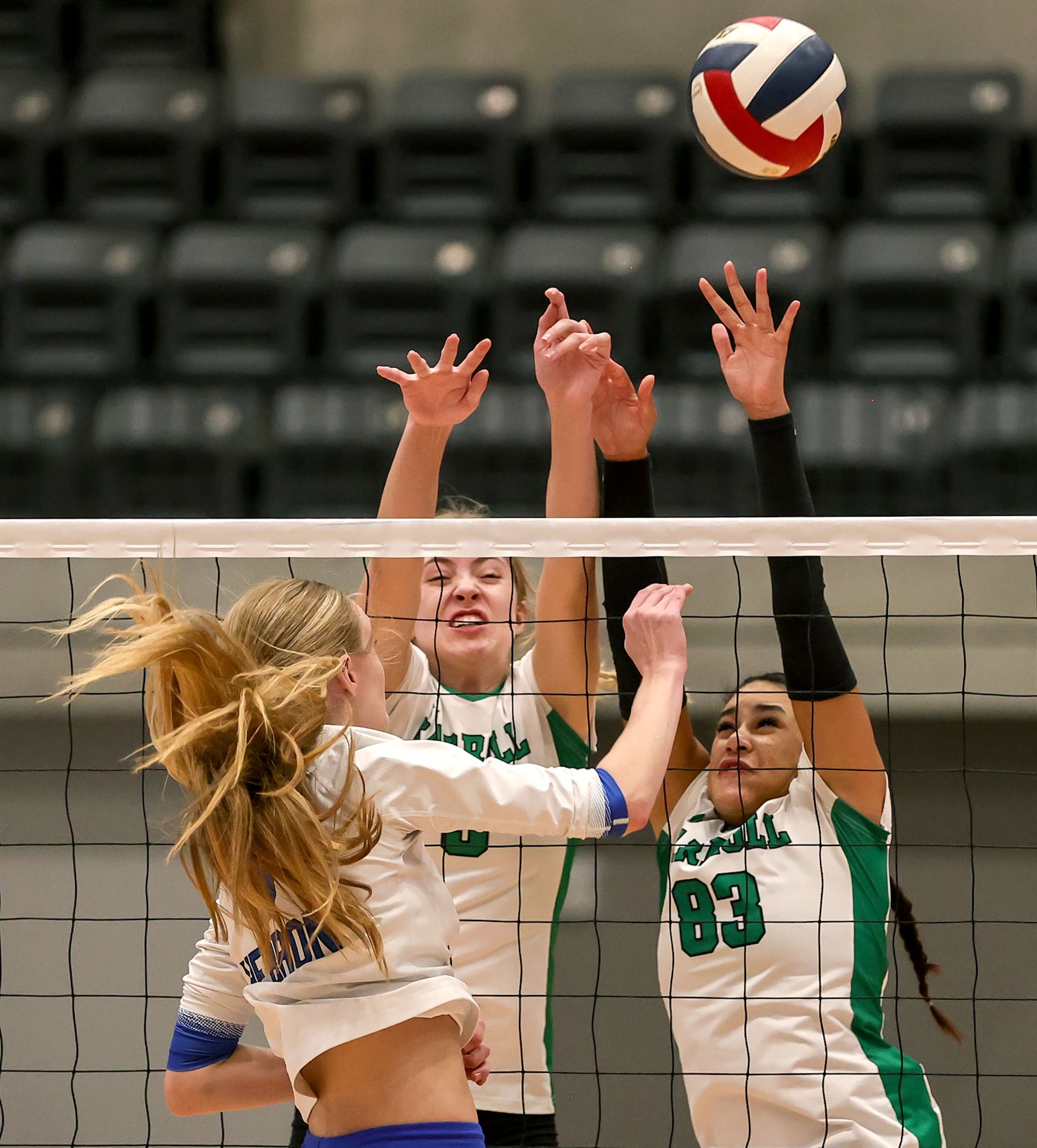 Hebron's Mary Beth Morse (L) tries to get a kill past Southlake Carroll's Abby Huddleston...