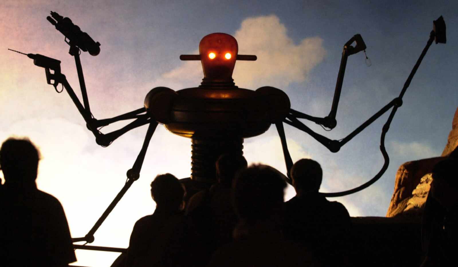 Visitors of the world exhibition Expo 2000 stand in front of a robot display at the "Planet...