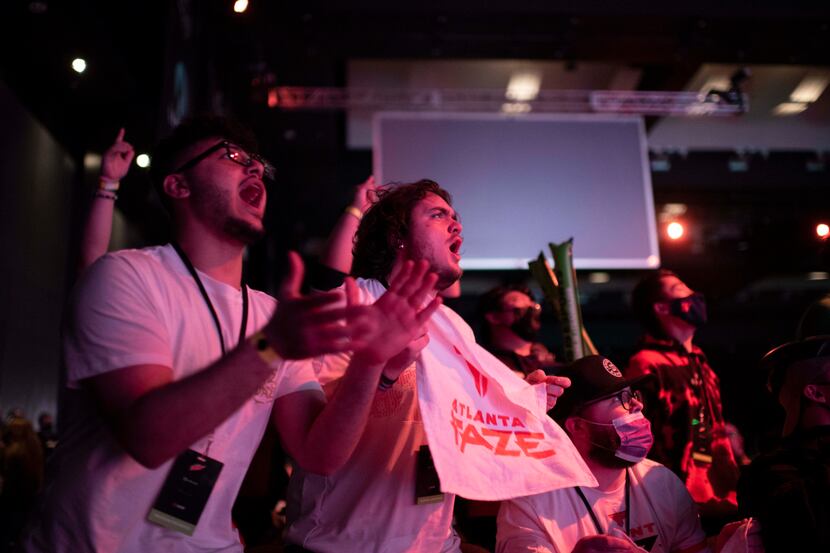 Hunter McDowell, center, cheers as the Atlanta FaZe win the first map during OpTic Texas'...