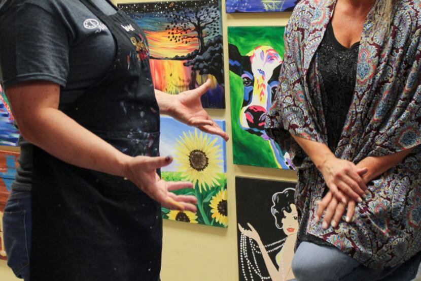 Bree Ann McCleskey, left, an instructor at Painting with a Twist in Rockwall, works...