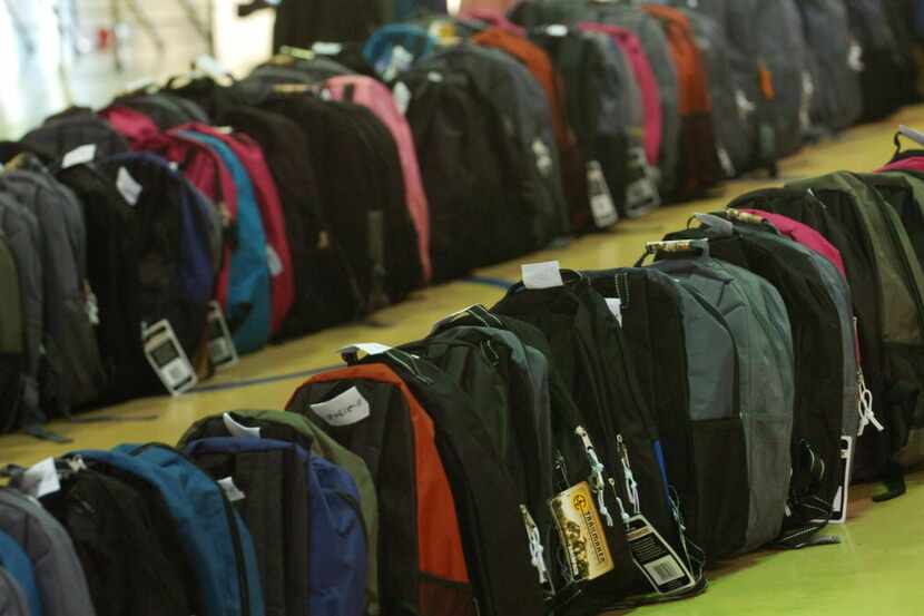 
Mountains of backpacks await distribution at Irving High School.
