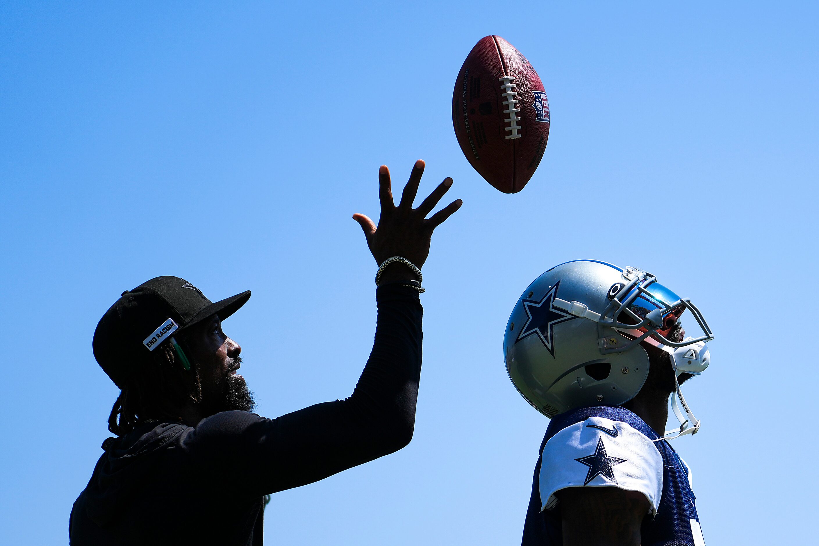 Dallas Cowboys cornerback Trevon Diggs (7) looks up for a ball tossed from behind his back...