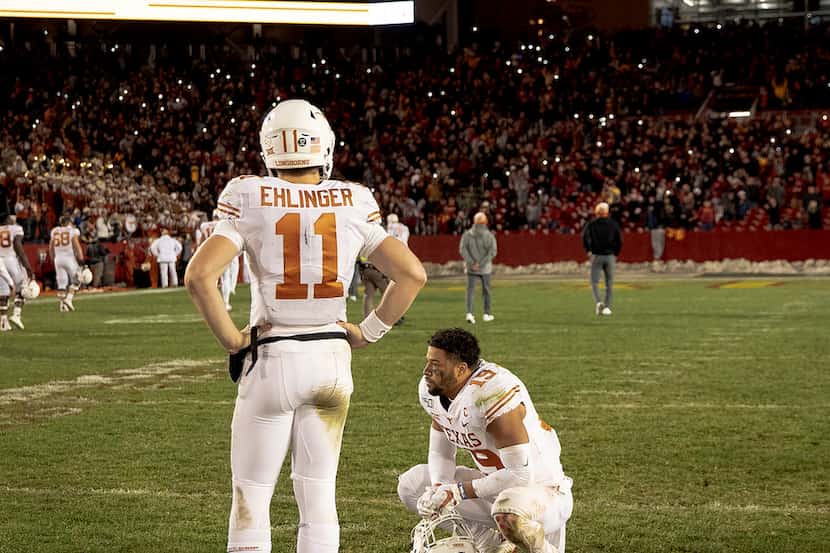 Texas quarterback Sam Ehlinger (11) and defensive back Brandon Jones (19) react after Iowa...