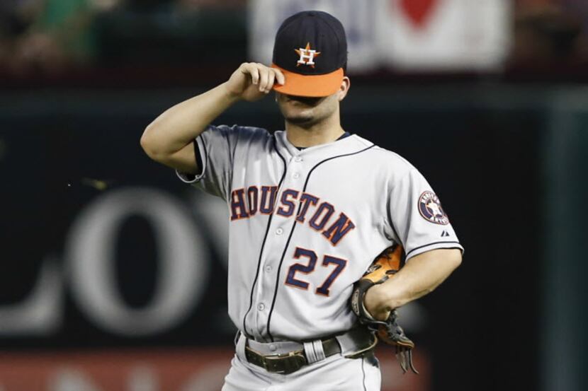 Houston Astros second baseman Jose Altuve adjusts his cap during the second inning of a...