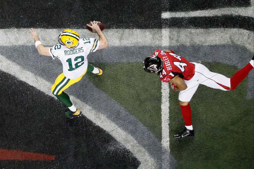 Green Bay Packers quarterback Aaron Rodgers (12) looks to pass as Atlanta Falcons outside...