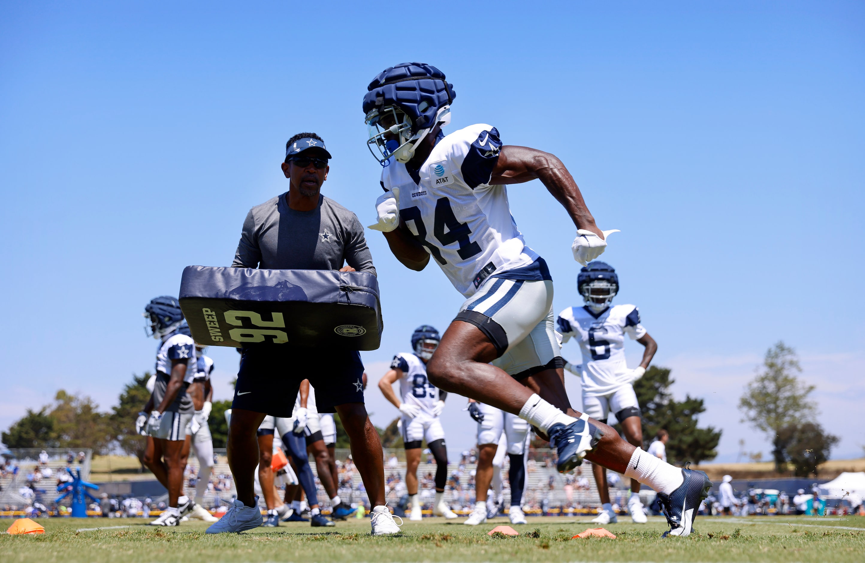 Dallas Cowboys wide receiver Kelvin Harmon (84) runs pass route drills with blocking...