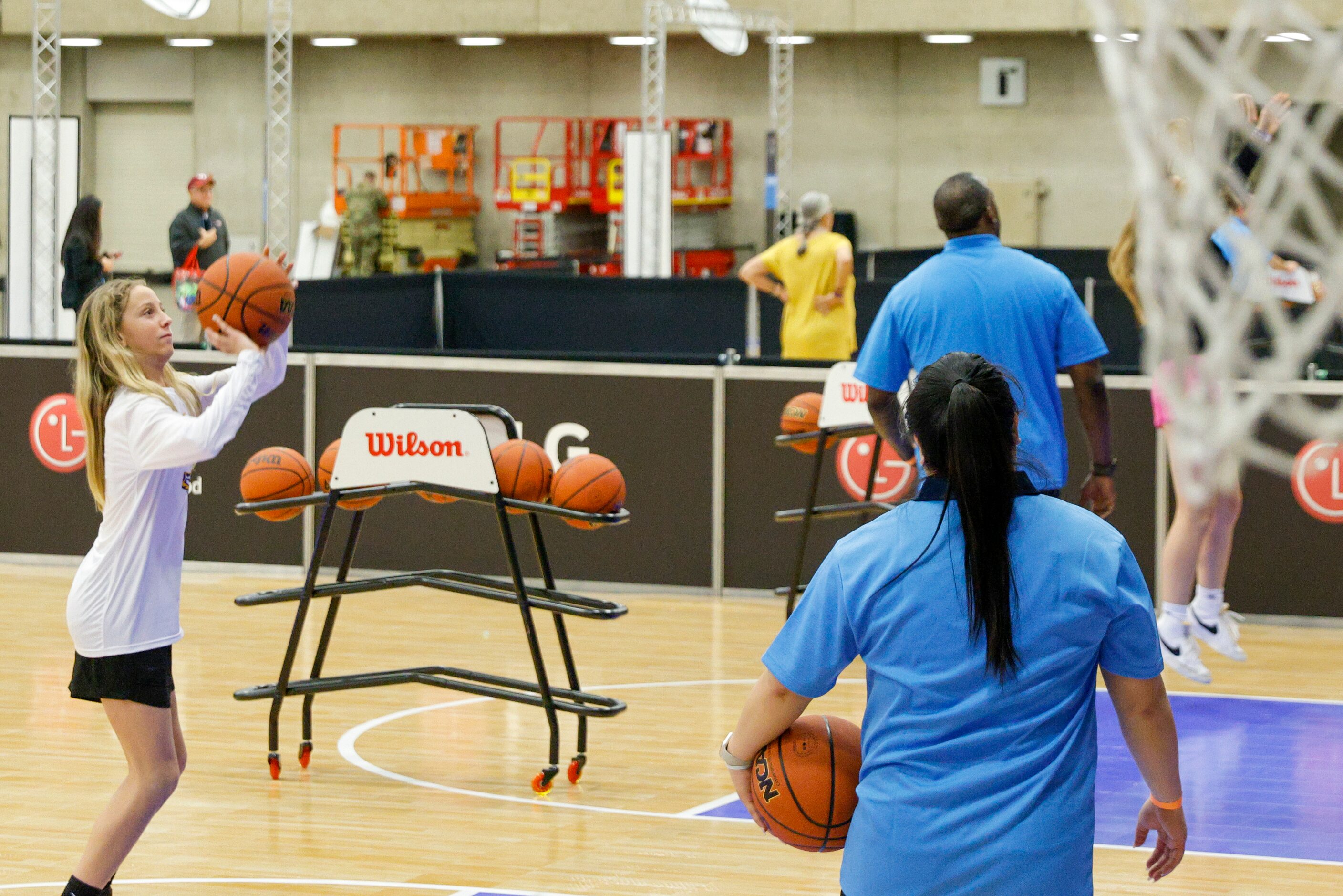 Sadie Lang, 12, of Illinois competes in a “Bracketball” shooting competition during the NCAA...