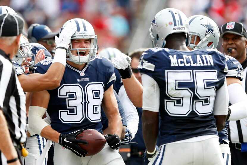 Dallas Cowboys strong safety Jeff Heath (38) celebrates with teammates after intercepting a...