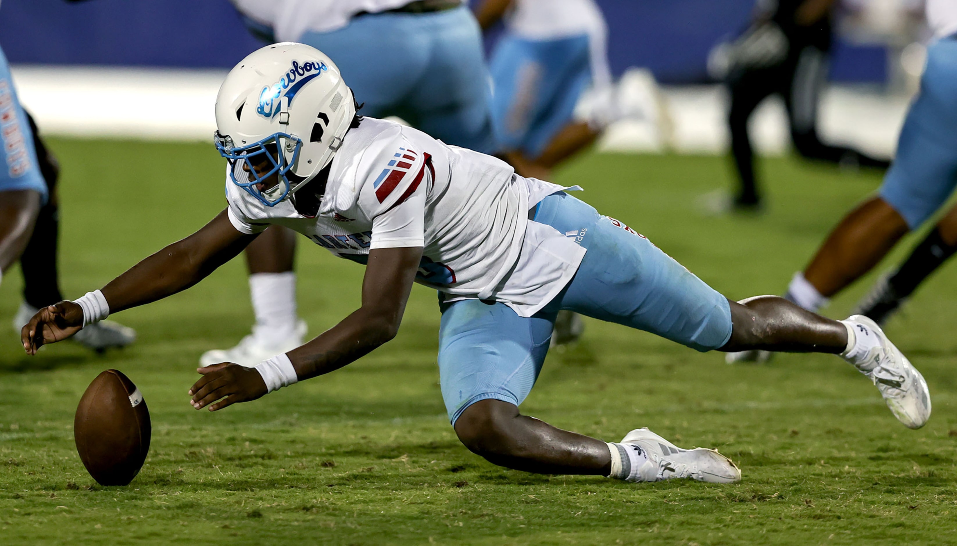 Dallas Carter quarterback Christopher Miller (5) fumbles, but gets his recovery against...