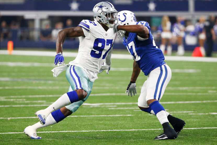 Dallas Cowboys defensive end Taco Charlton (97) passes by Indianapolis Colts tight end...