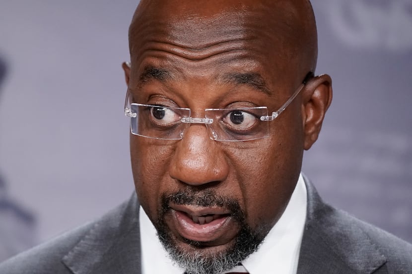 FILE - Sen. Raphael Warnock, D-Ga., speaks to reporters at the Capitol in Washington, July...