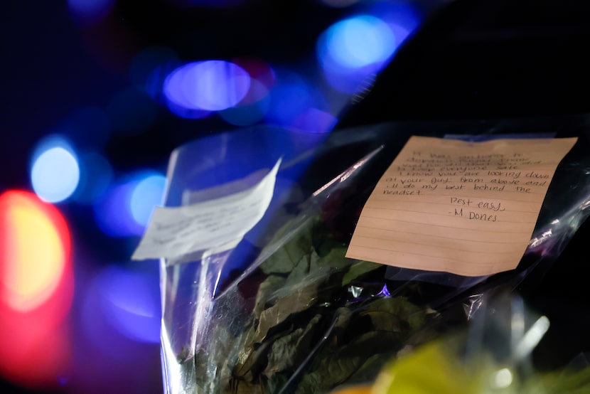 Handwritten messages were placed on a service vehicle during the vigil for Fort Worth police...