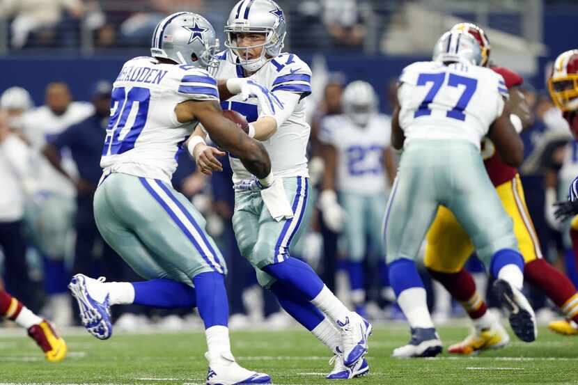 Dallas Cowboys quarterback Kellen Moore (17) hands the ball off to running back Darren...
