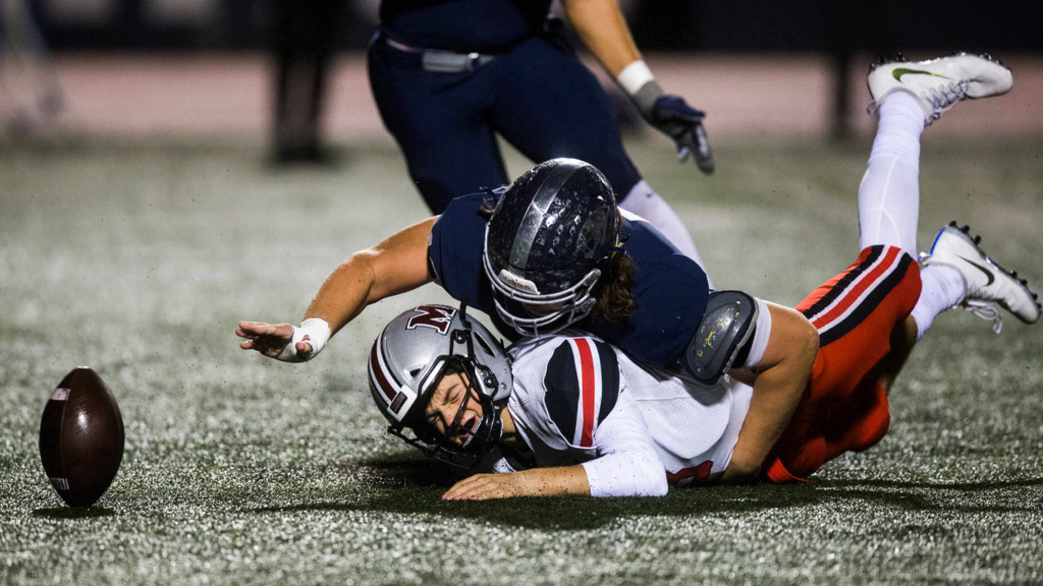 Flower Mound Marcus quarterback Garrett Nussmeier (13) loses the ball as he is sacked by...