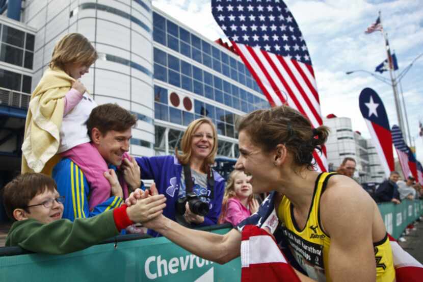Serena Burla (right) shakes hands with fan, Conner Hughes, 9, after Burla won second place...