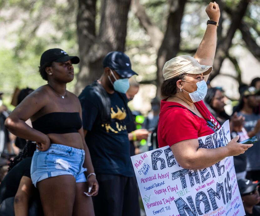 Valerie Fields Hill listens to speakers during a demonstration denouncing police brutality...