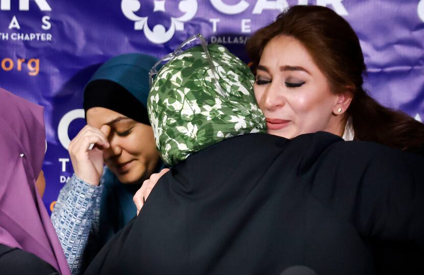 Rola Abunasser (right) is comforted after speaking at a news conference Thursday about her...
