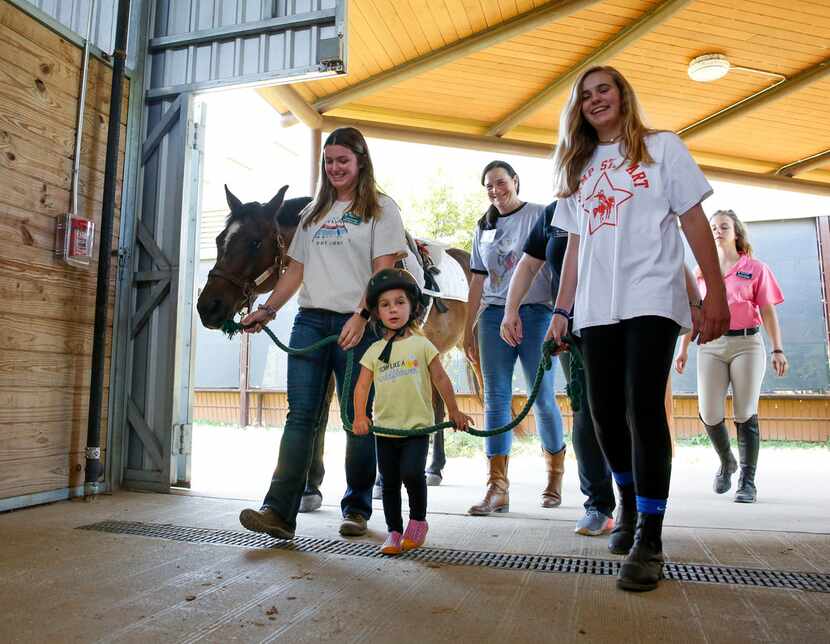 Mora Wolf leads Hombre back to the barn after her 30-minute occupational therapy session at...