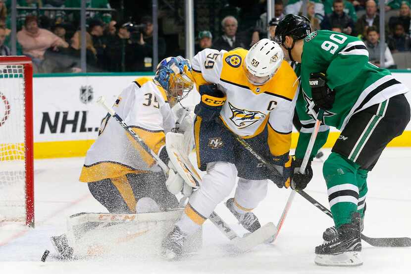 Nashville Predators goaltender Pekka Rinne (35) deflects a shot on goal as Dallas Stars...