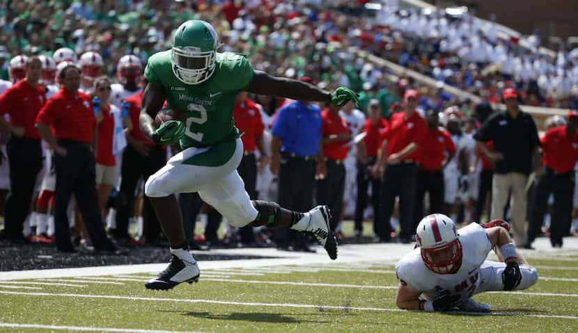 North Texas Mean Green running back Reggie Pegram (2) runs the ball after breaking a tackle...