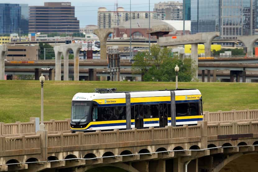 
The streetcar is powered by two 550-volt batteries as it crosses the Trinity River on the...