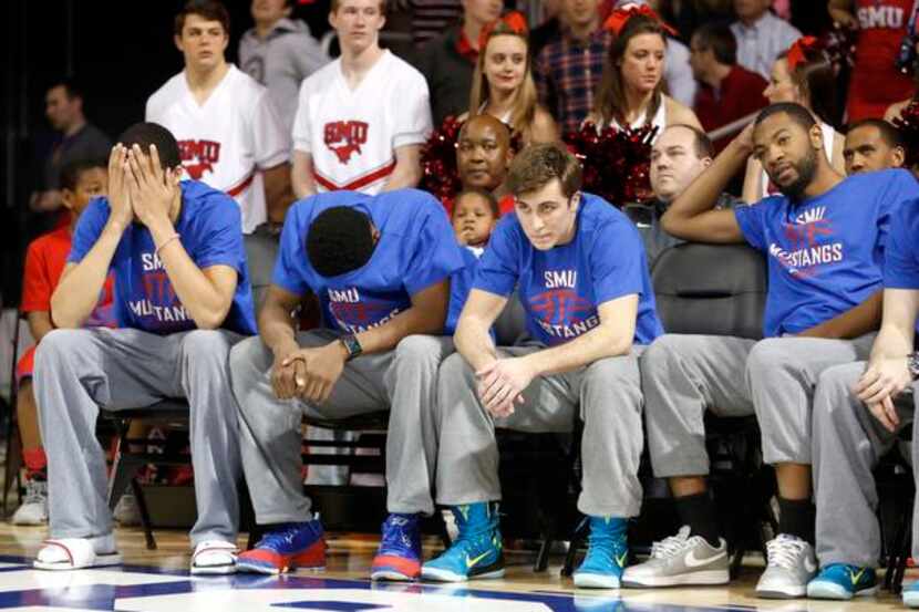 
Blue during Moody Coliseum’s watch party were SMU Mustangs (from left) Cannen Cunningham,...