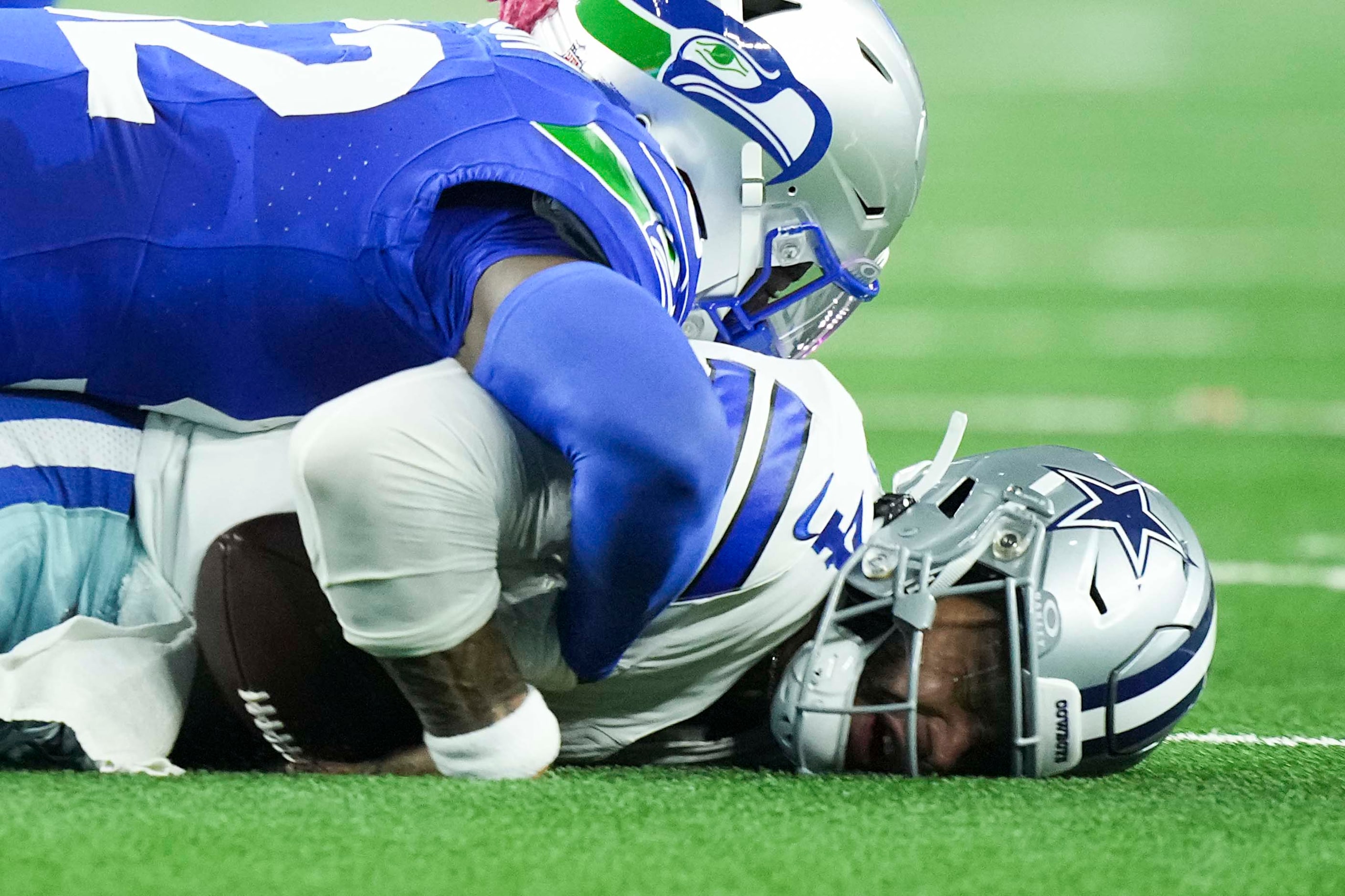 Dallas Cowboys quarterback Dak Prescott (4) is sacked by Seattle Seahawks linebacker Darrell...