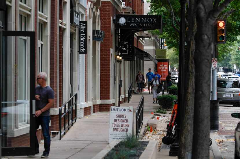 Shoppers wandered into stores and walked down the sidewalk at the West Village in Dallas.