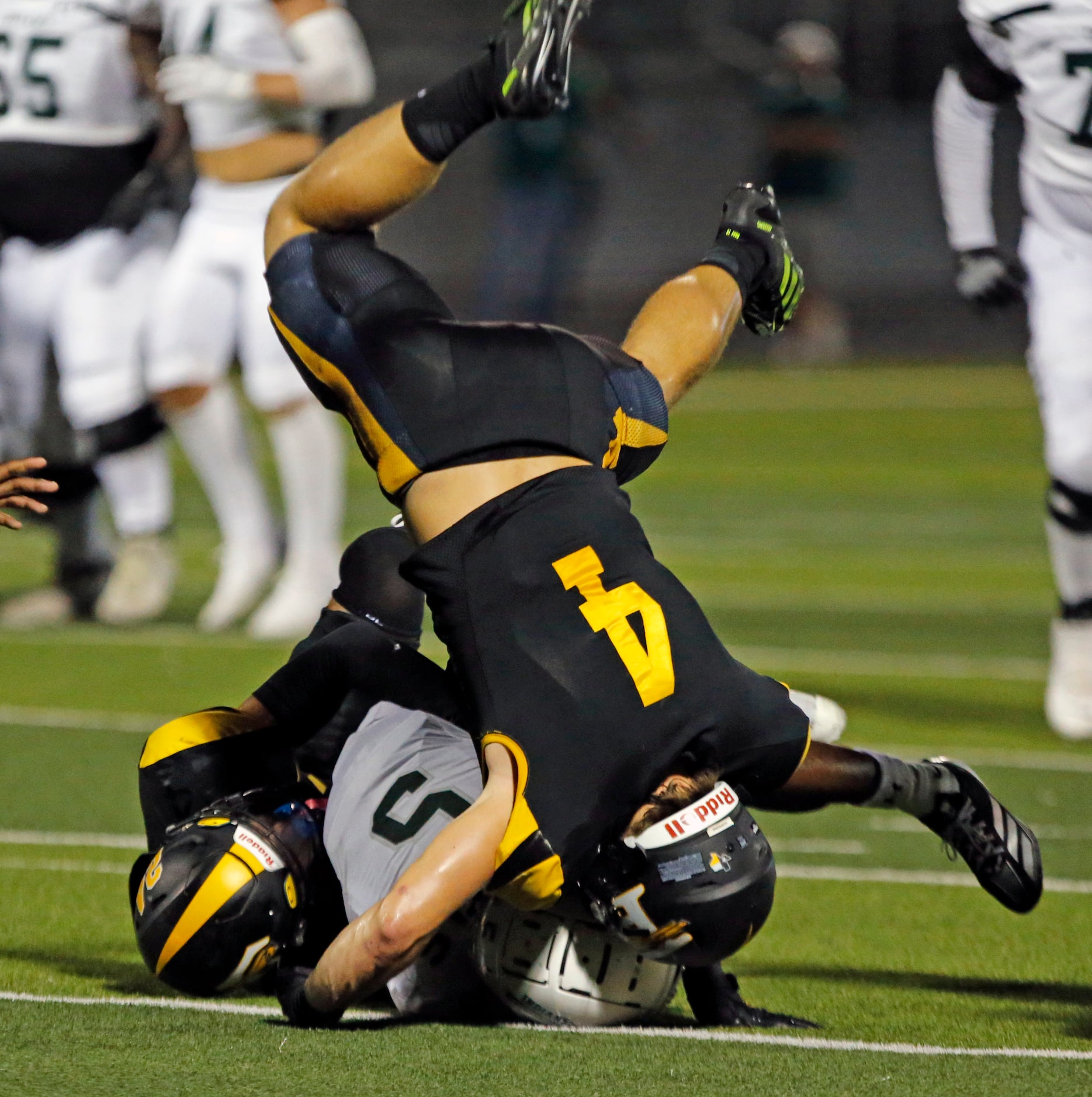 Forney defender Landry Hopkins (4) cartwheels in the air, while helping stop Waxahachie’s...