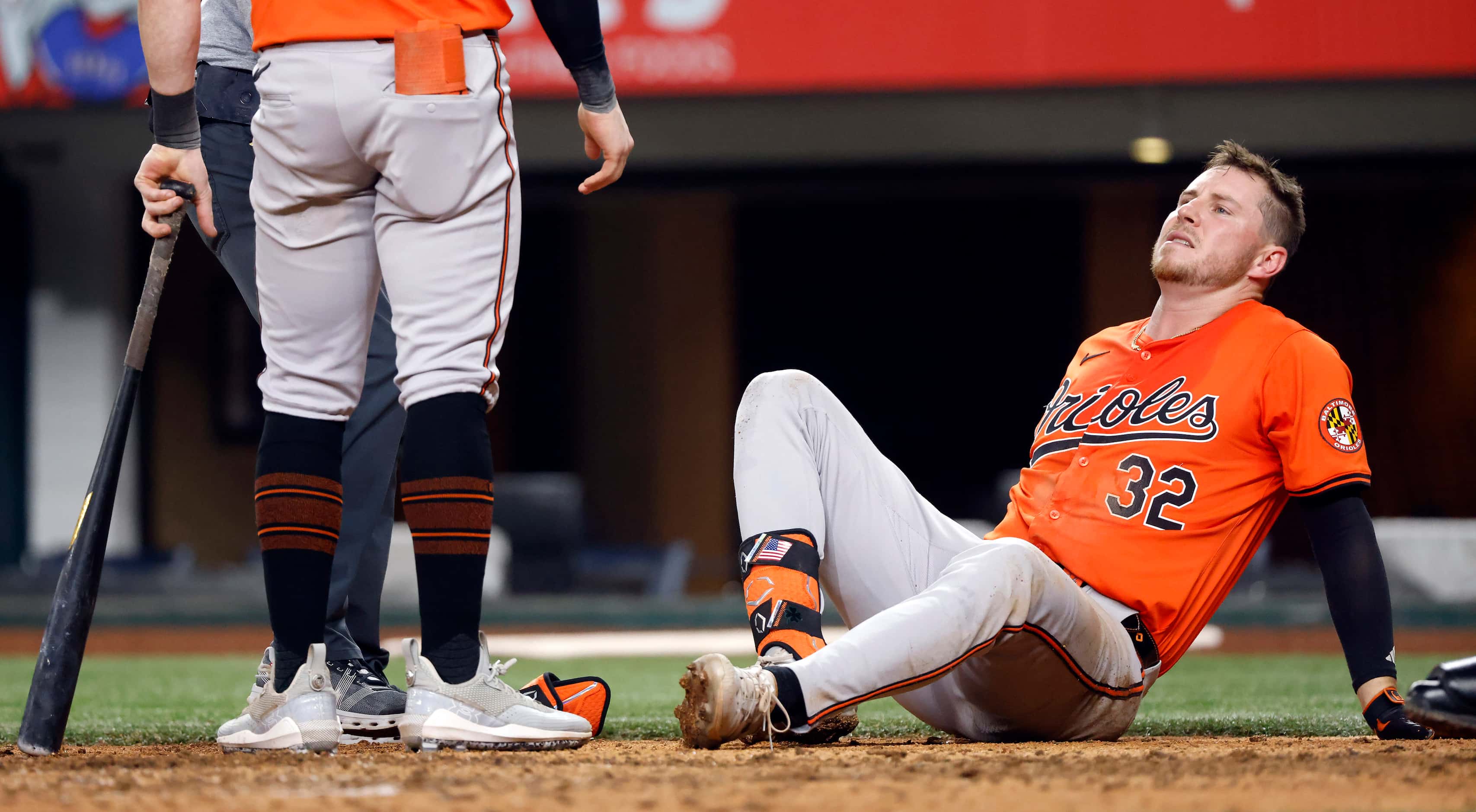 Baltimore Orioles batter Ryan O'Hearn (32) winces in pain after being hit by Texas Rangers...
