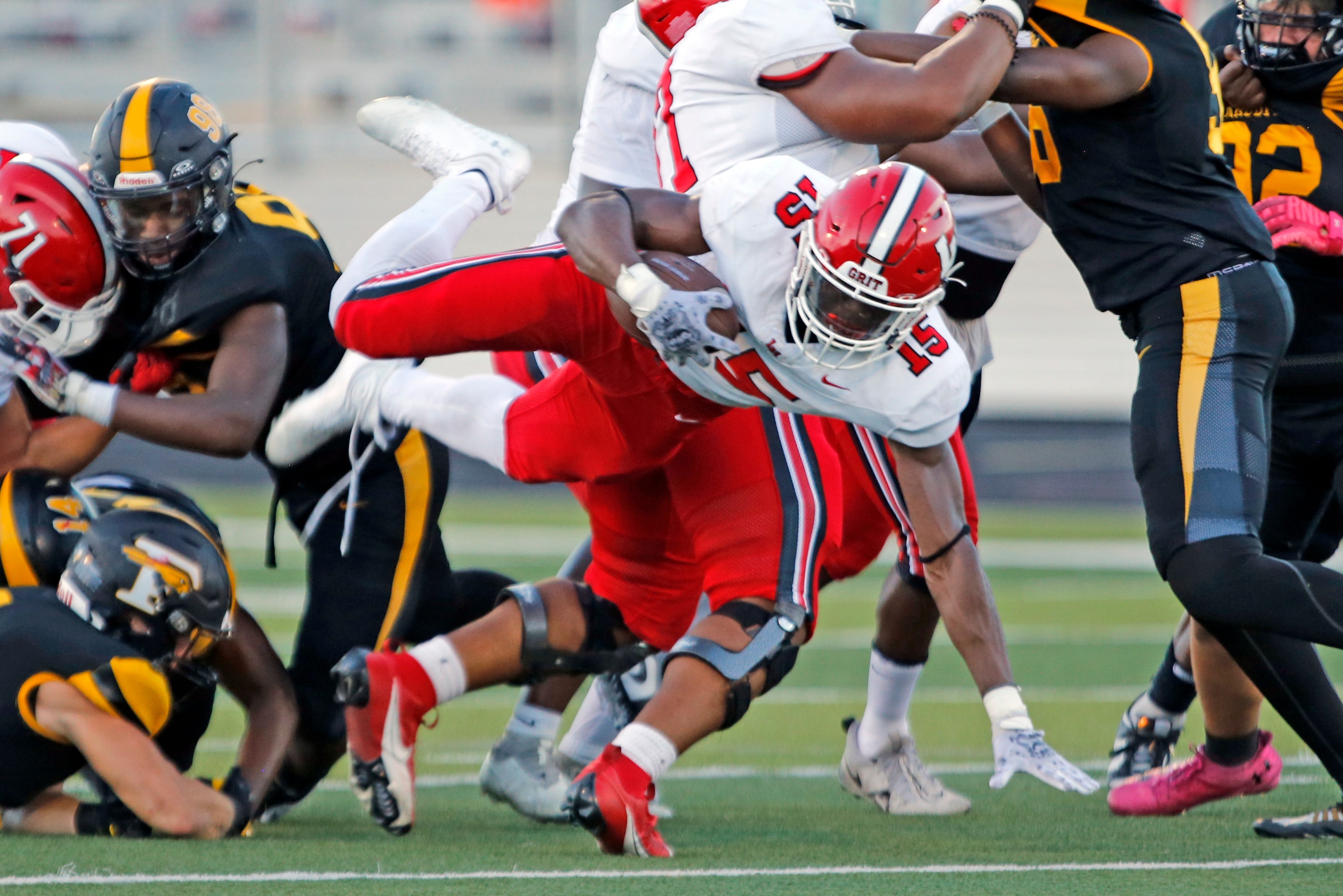 Lake Highlands Christian Rhodes (15) picks up a couple of yards during the first half of a...