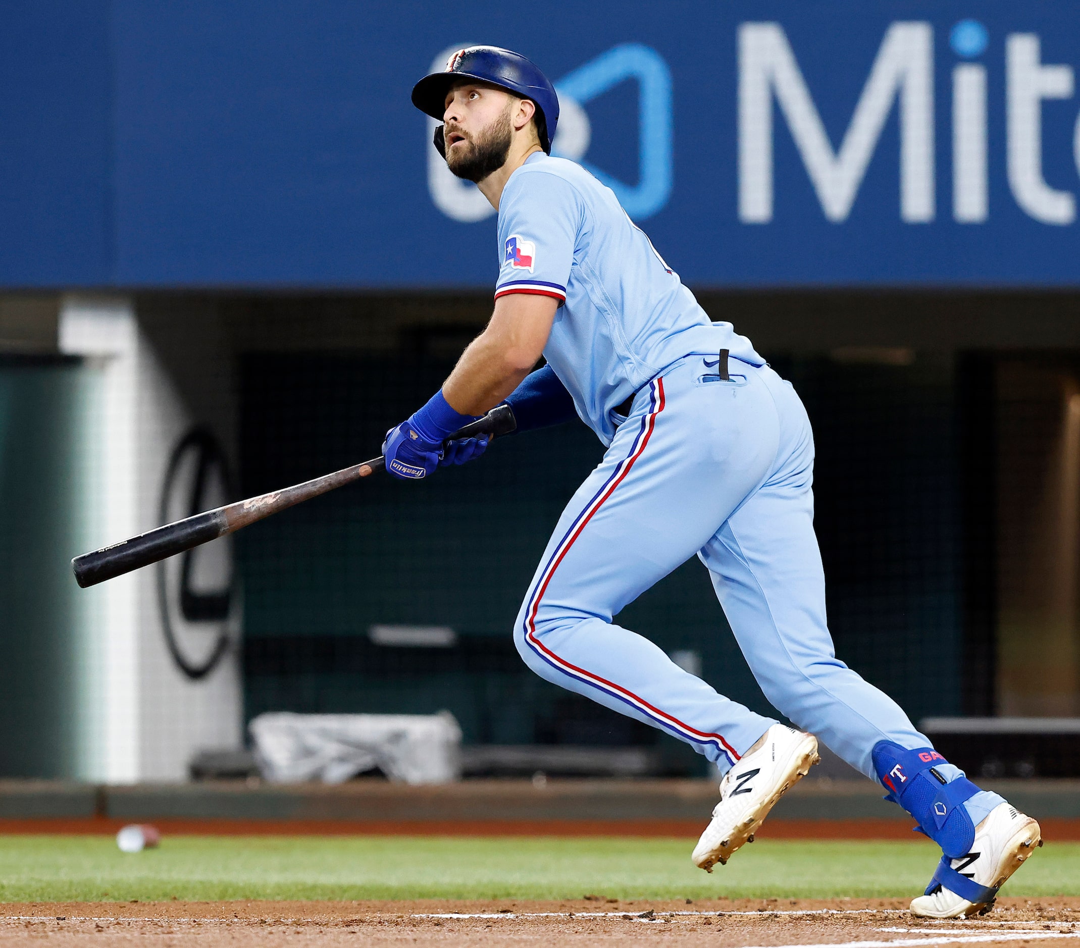 Texas Rangers batter Joey Gallo (13) watches his two-run homer to left field in the first...