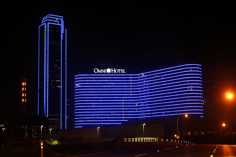 The Bank of America Plaza (left) and the Omni Dallas Hotel are lit in blue to show support...