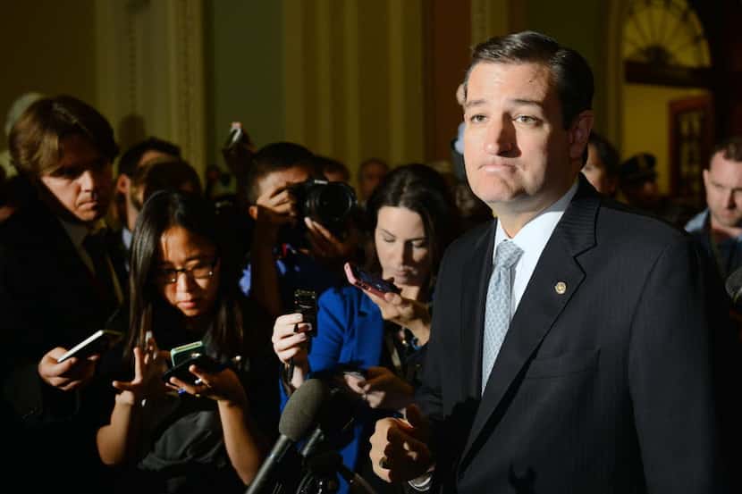 Sen. Ted Cruz (R-TX) pauses as he speaks to the media after Senate leaders announced a deal...