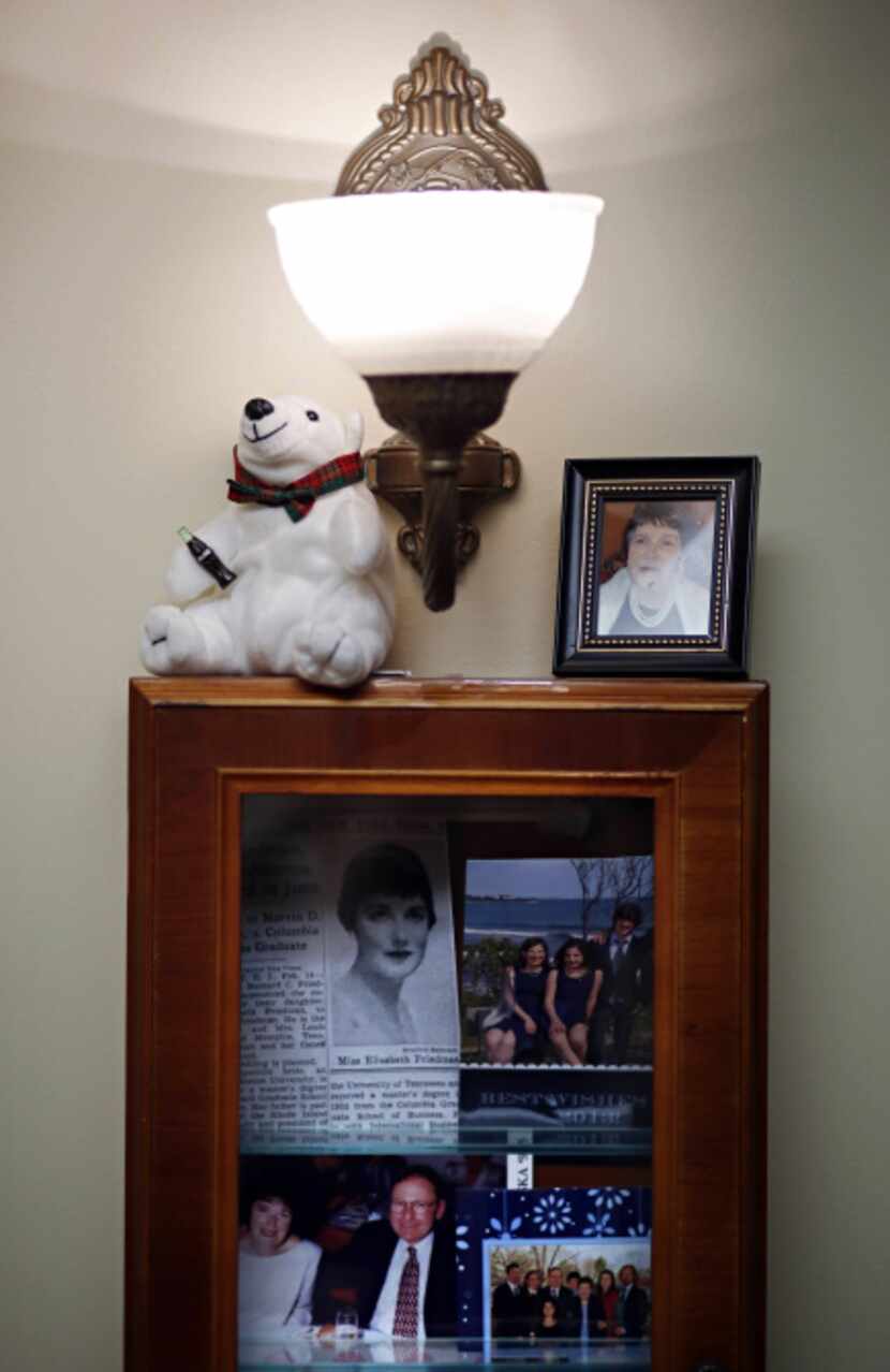 A patient's shadow box is mounted to the wall outside of an apartment in the Memory Support...