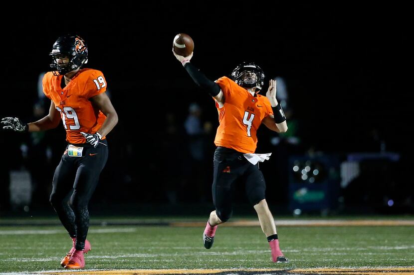 Aledo quarterback Jake Bishop (4) throws a pass downfield over teammate Tre Owens during the...