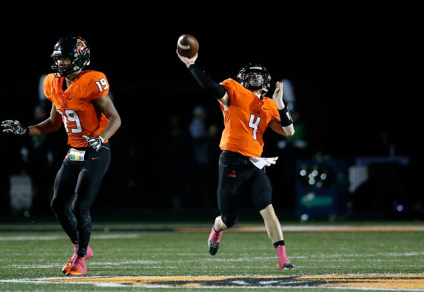 Aledo quarterback Jake Bishop (4) throws a pass downfield over teammate Tre Owens during the...