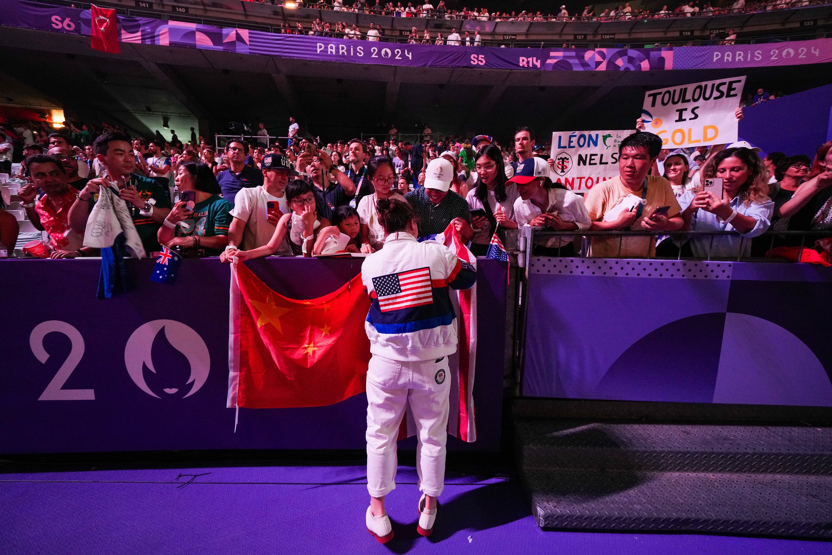 A US athlete signs autographs during closing ceremonies for the 2024 Summer Olympics on...