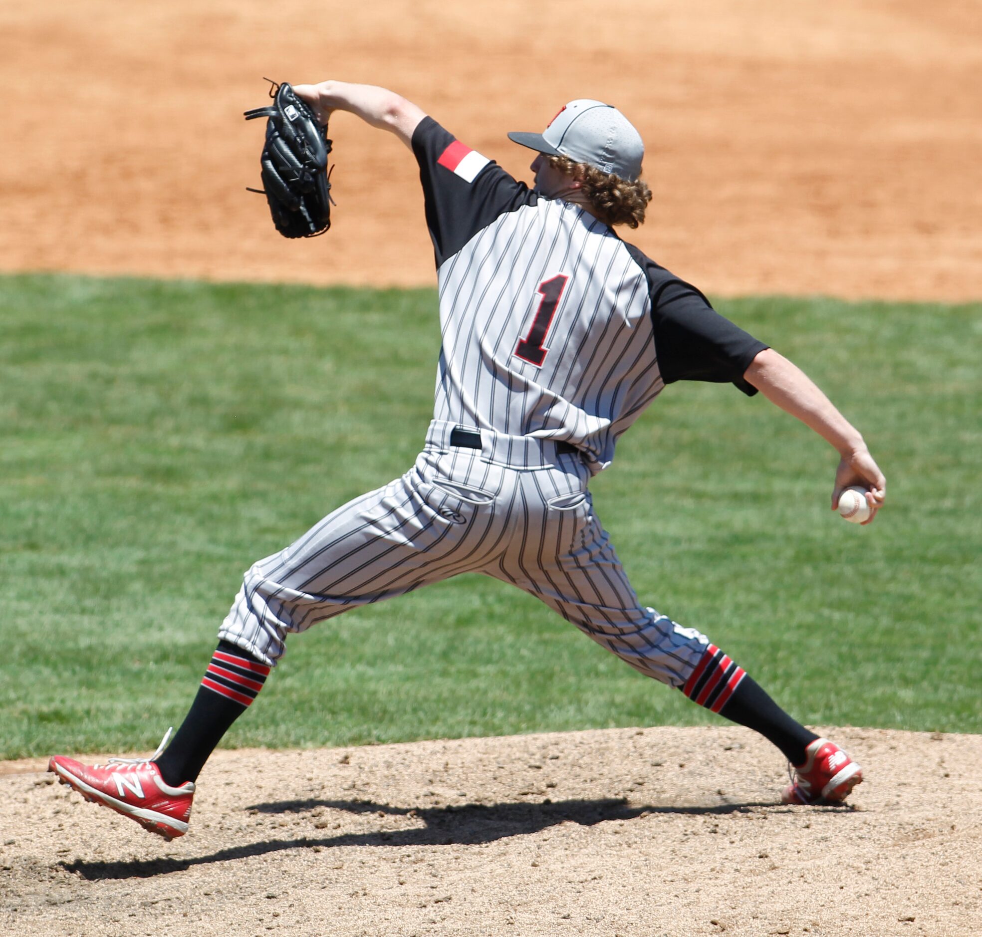 Rockwall Heath pitcher Baylor Baumann (1) delivers a pitch to a Rockwall batter enroute to...