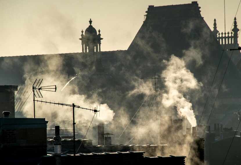 Chimneys release smoke on a freezing day in the city of Lille in northern France on December...