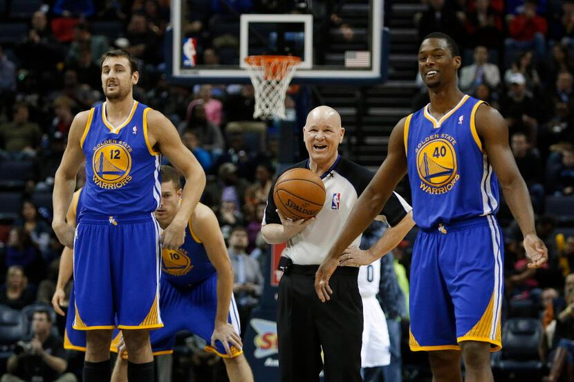 A referee jokes with Golden State Warriors center Andrew Bogut (12), of Australia, and...