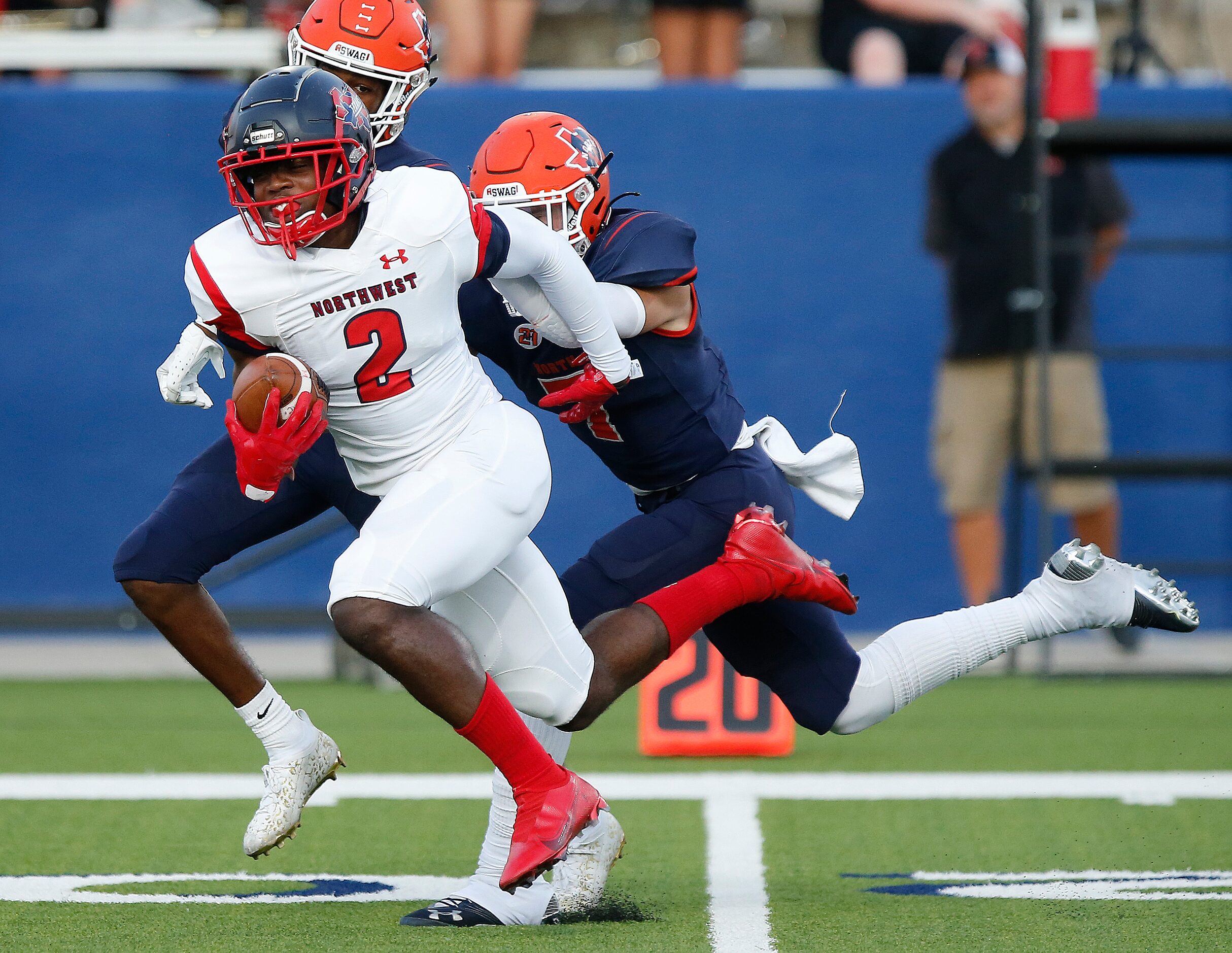 Northwest High School Ricardo Dyer jr. (2) is tackled by McKinney North High School...