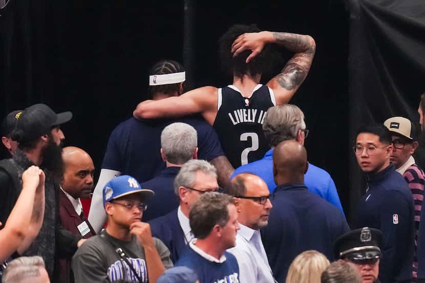 Dallas Mavericks center Dereck Lively II (2)leaves the court after being injured during the...