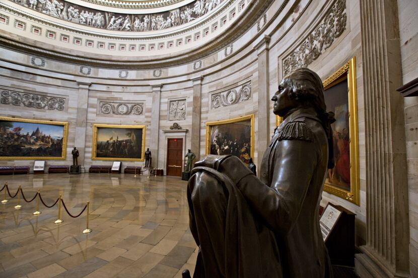 A statue of President George Washington is seen in the Rotunda of the U.S. Capitol as...