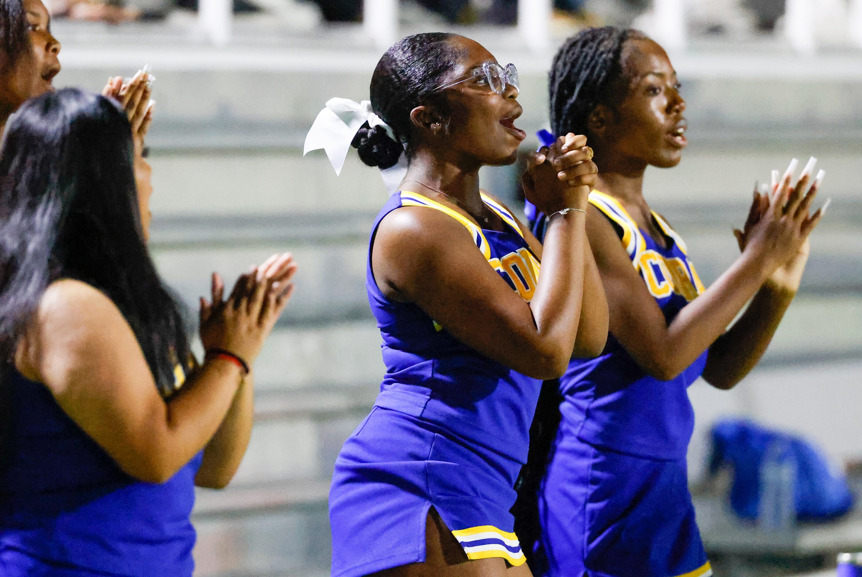 Conrad High School cheerleaders encourage their team as they play Woodrow Wilson at Forester...