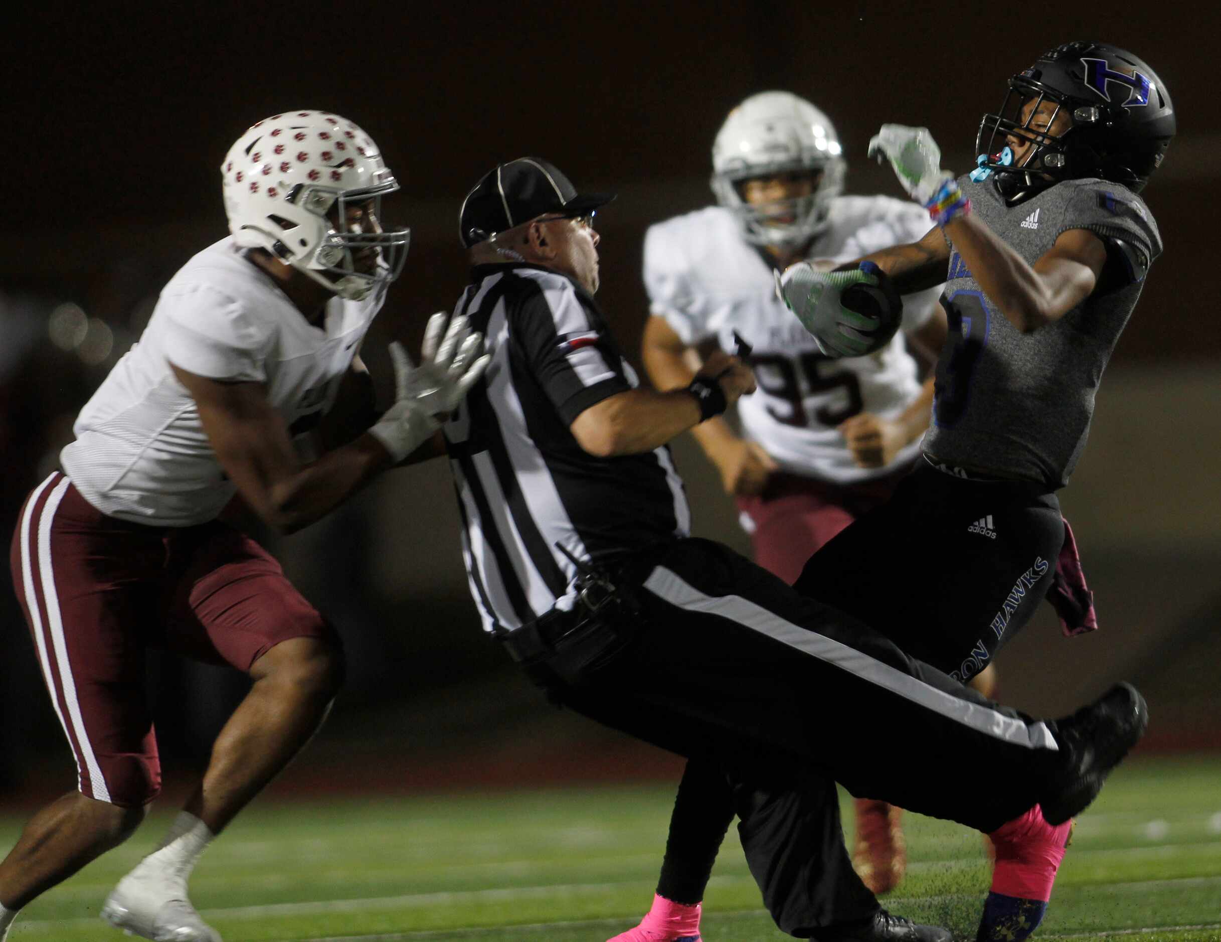 Hebron receiver Cobye Baldwin (3), right,  collides with umpire Eric Horton in the Plano...