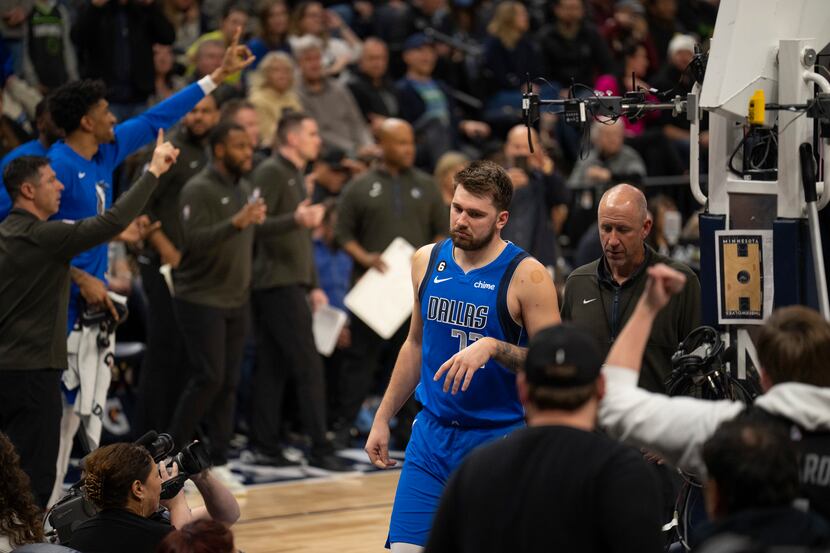 Dallas Mavericks guard Luka Doncic (77), center, leaves the court after being ejected during...